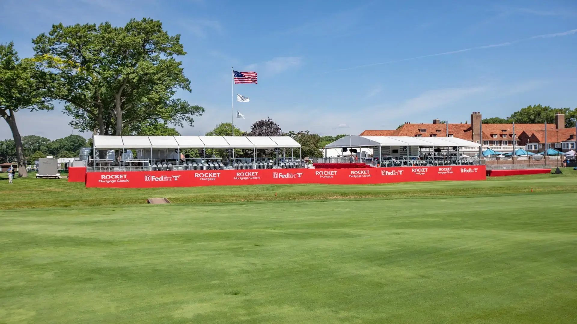 InProduction hospitality structure with premium seating and sponsor-branded mesh installed on-course for the Rocket Mortgage Classic to enhance spectator experience.