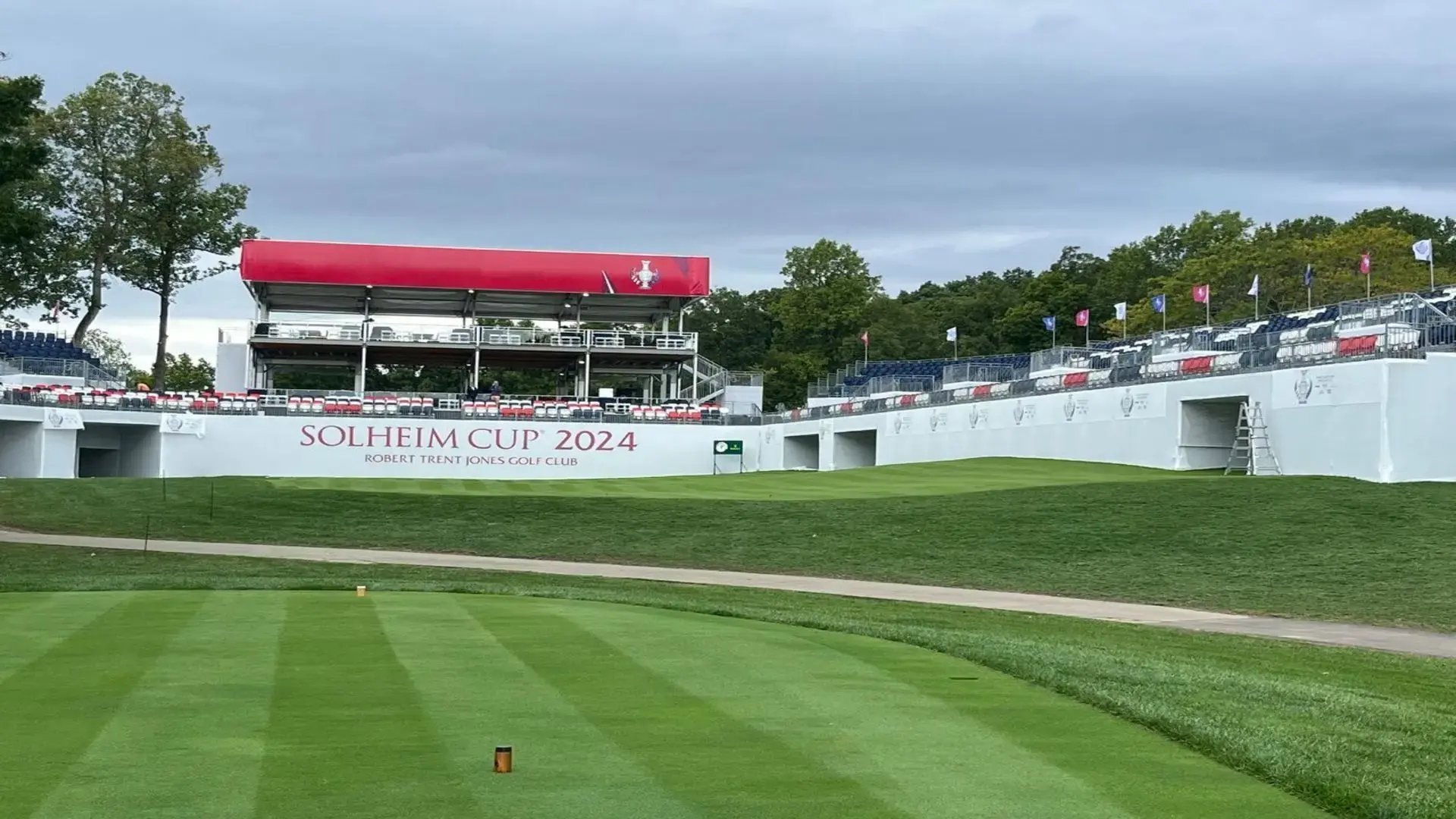 InProduction hospitality suites, grandstand seating, and custom mesh branding installed for the Solheim Cup to create a fan-focused tournament environment.