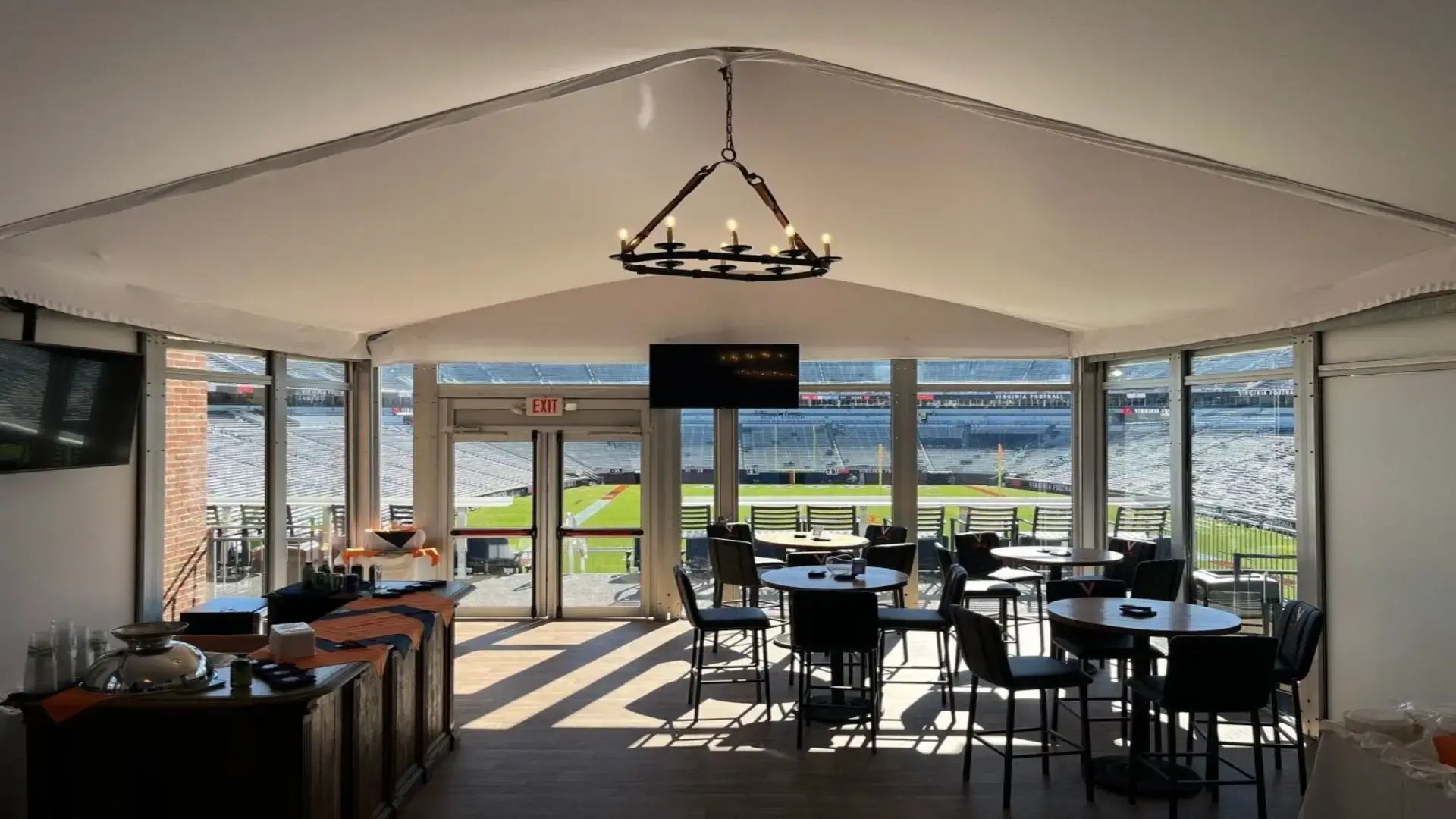 InProduction modular hospitality suite interior at the University of Virginia, featuring elevated seating and premium viewing overlooking the field to enhance fan experience.