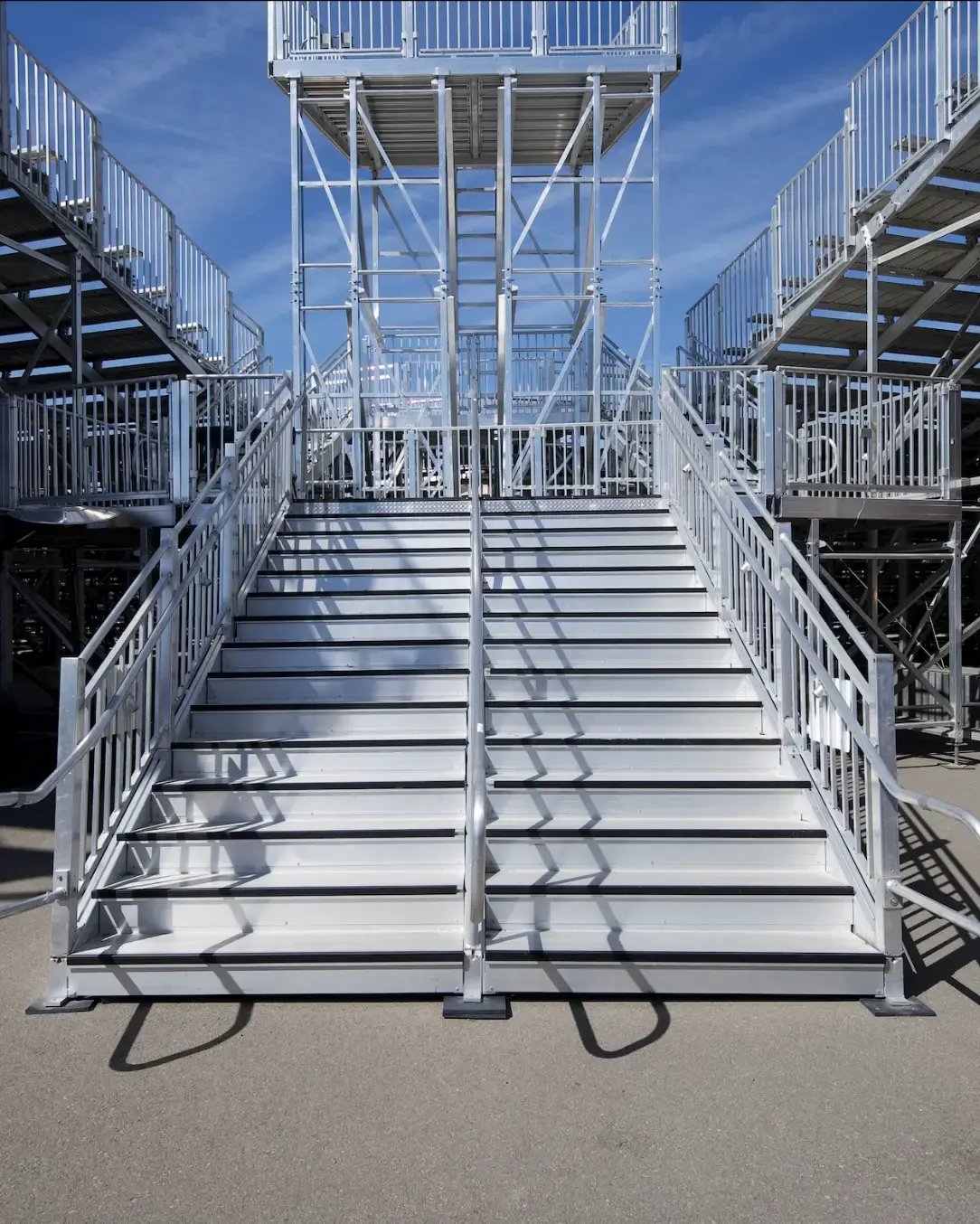 Stair systems combined with elevated walkways to ensure safe, efficient audience circulation.
