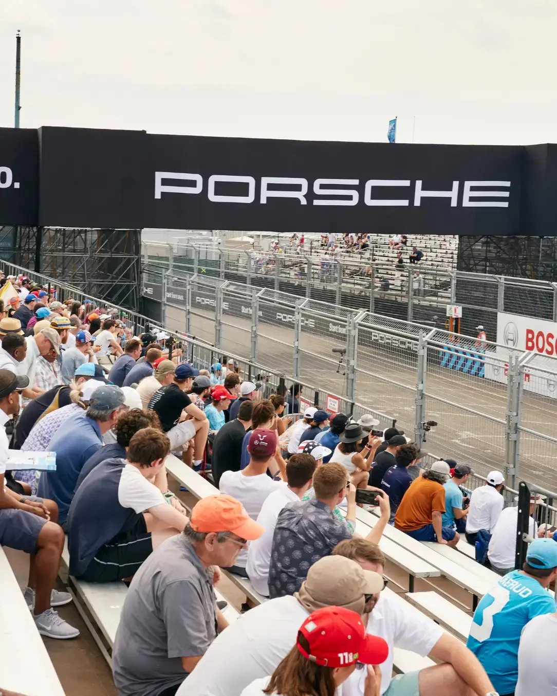 Pedestrian bridge providing elevated spectator access at an urban street race venue.