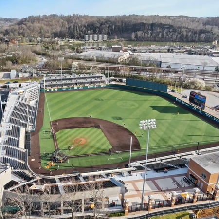 Aerial view of an empty collegiate baseball stadium with stands and field visible.