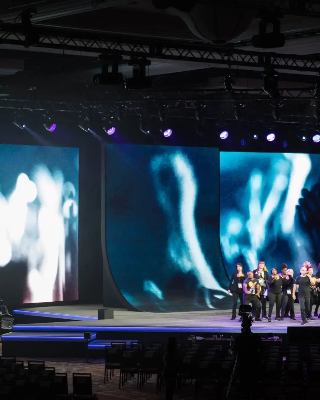 Modular stage installed in a convention center for a corporate general session with professional presentation.  