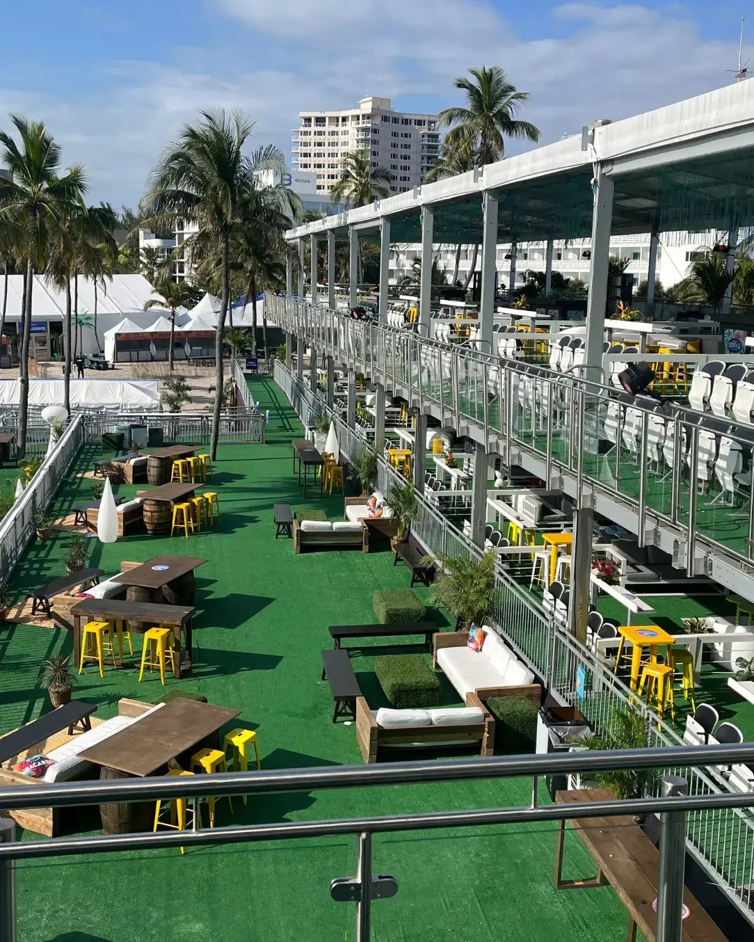 Elevated hospitality structures built on the sand to provide premium guest experiences at a music festival. 