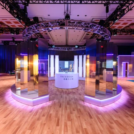 Custom scenic environment with fabricated structures and event design elements.