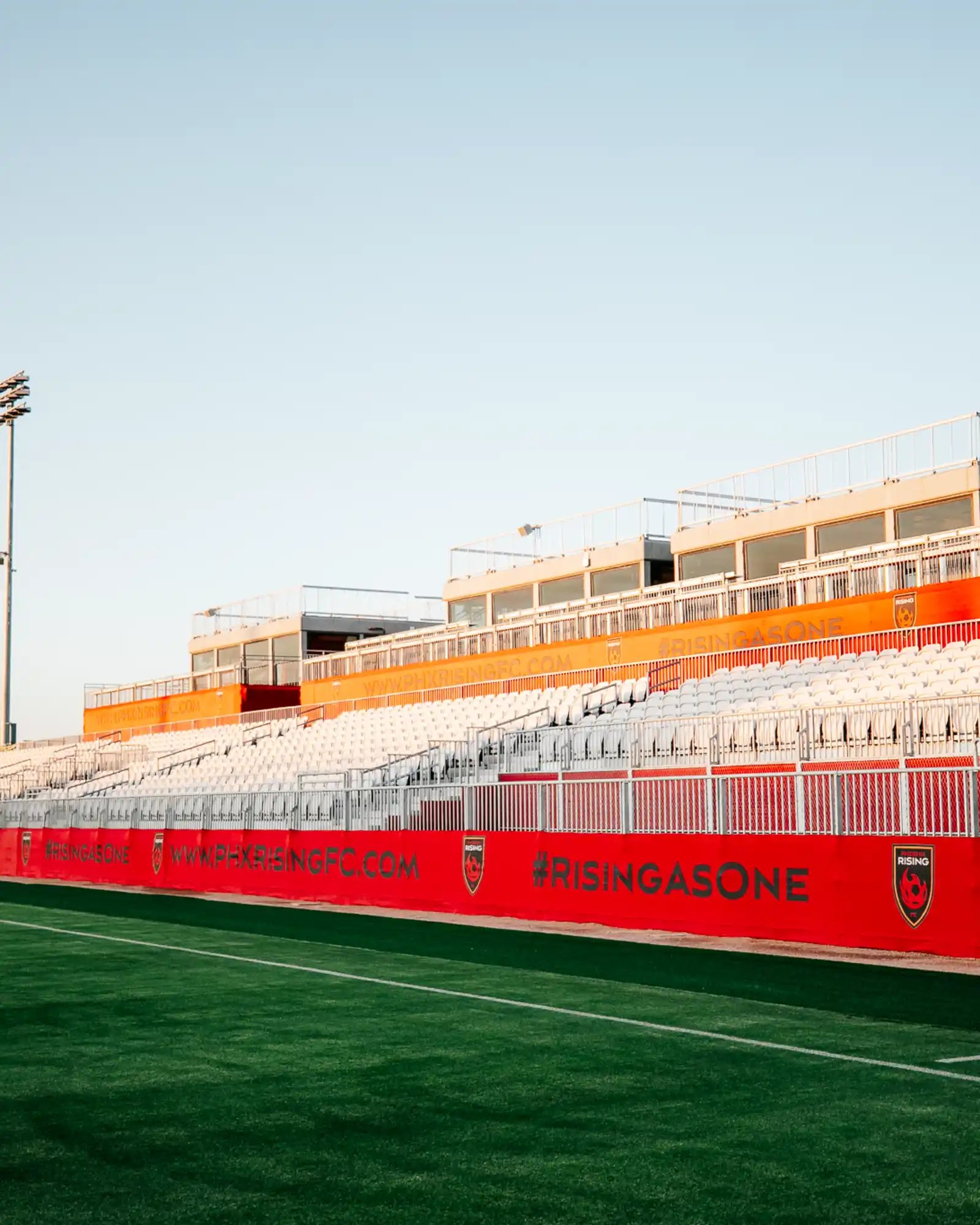 Empty custom-built modular stadium seating with Phoenix Rising FC branding.
